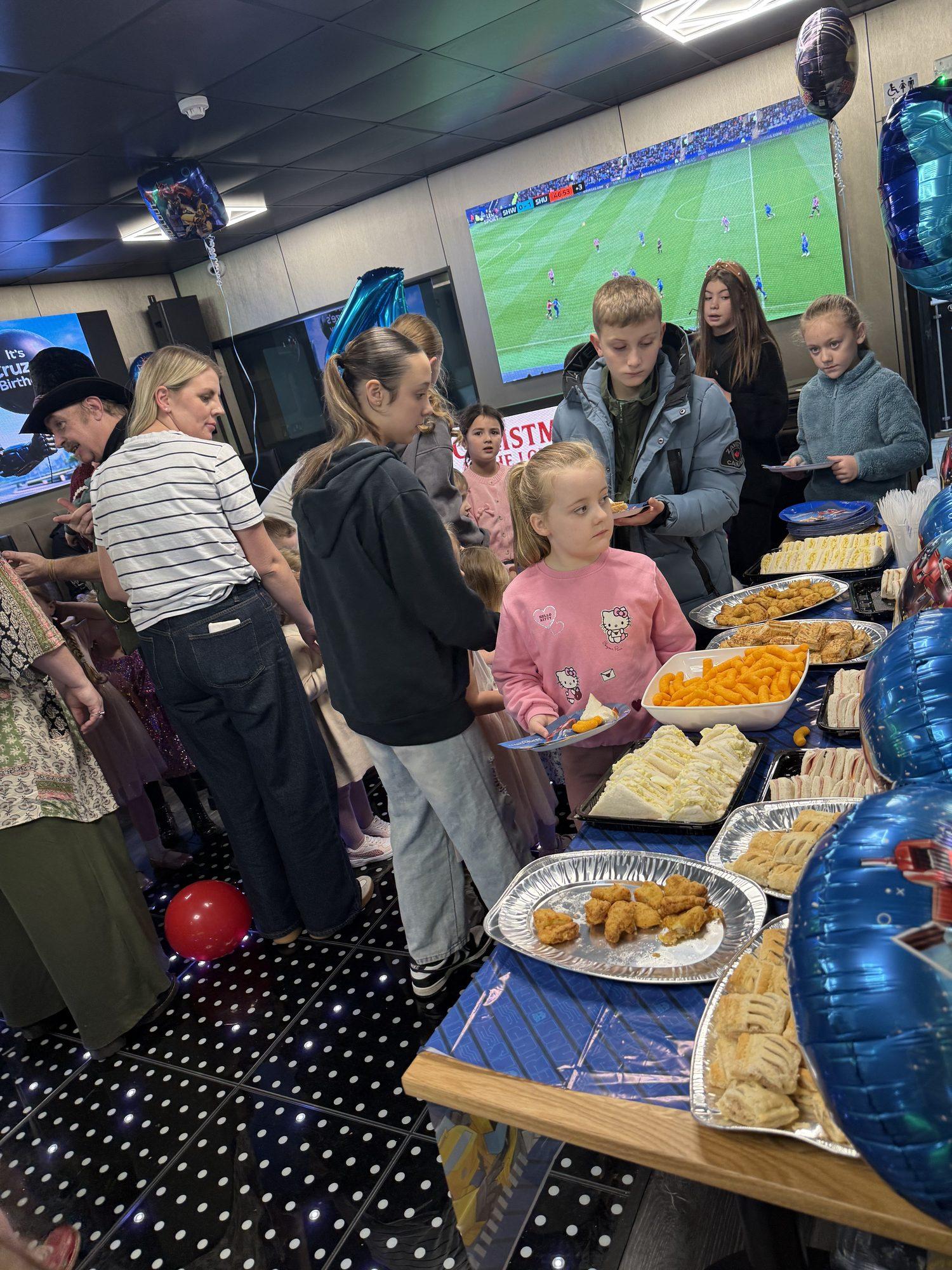 Guests helping themselves to a party buffet with blue balloons at The Lounge Rotherham