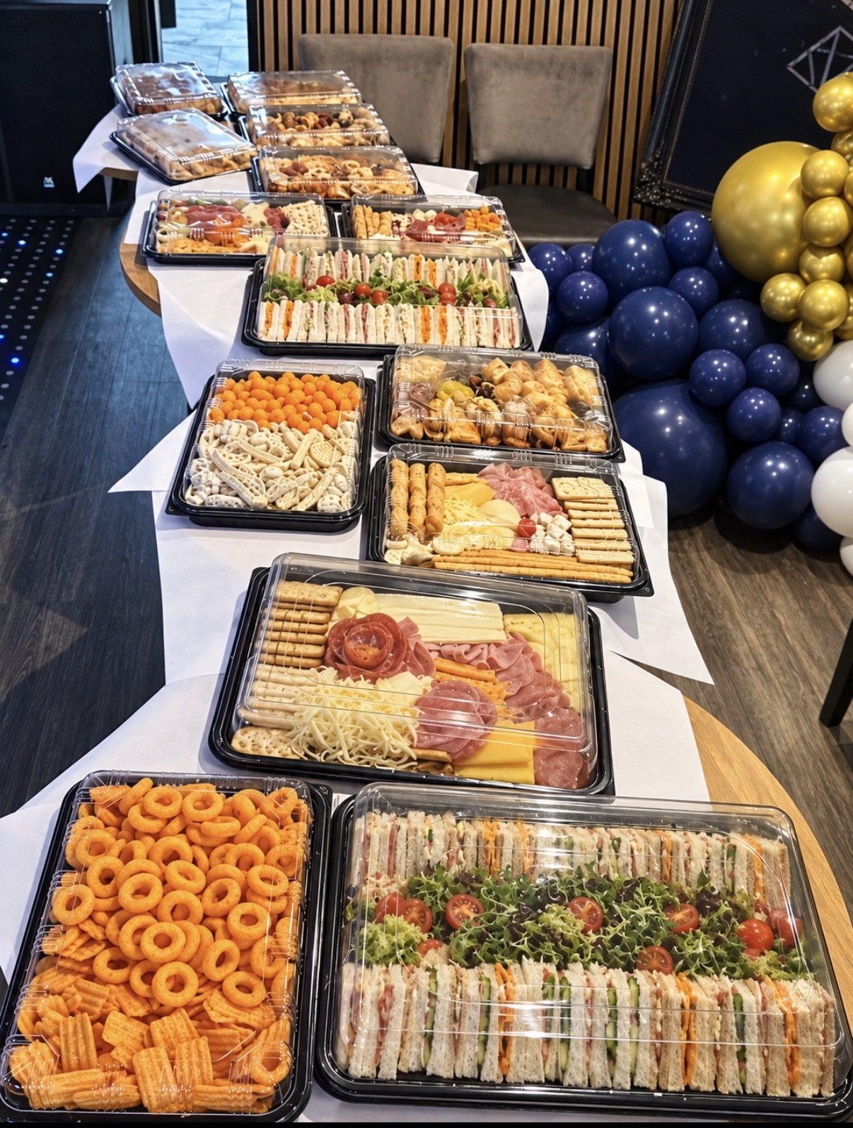Long buffet table set for a birthday party with navy and gold balloons at The Lounge Rotherham